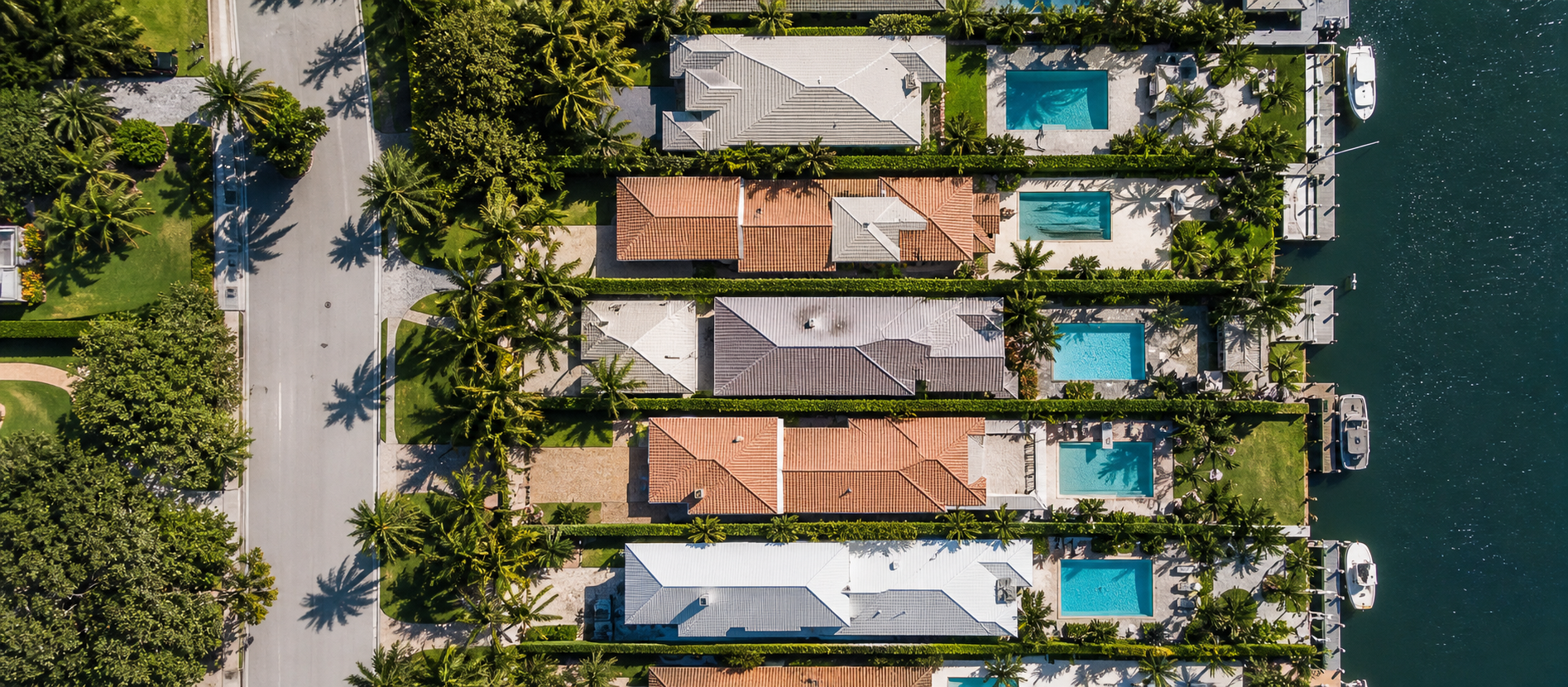 Aerial of a palm-lined South Florida residential block, canals visible